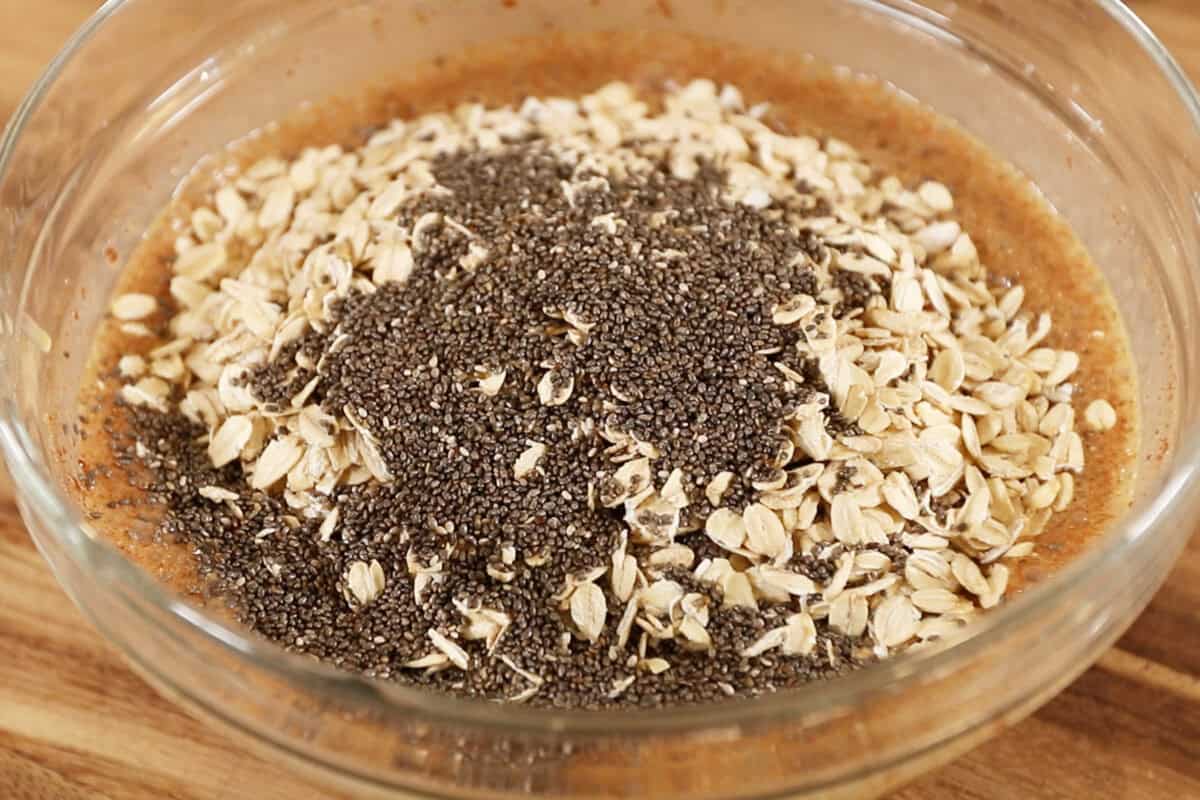 adding oats and chia seeds to bowl
