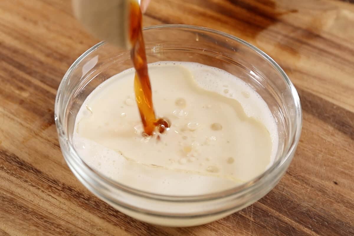 adding vanilla extract to small bowl