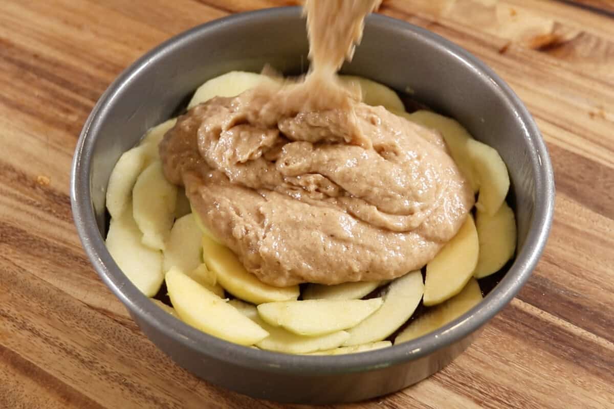 pouring the batter over the apples