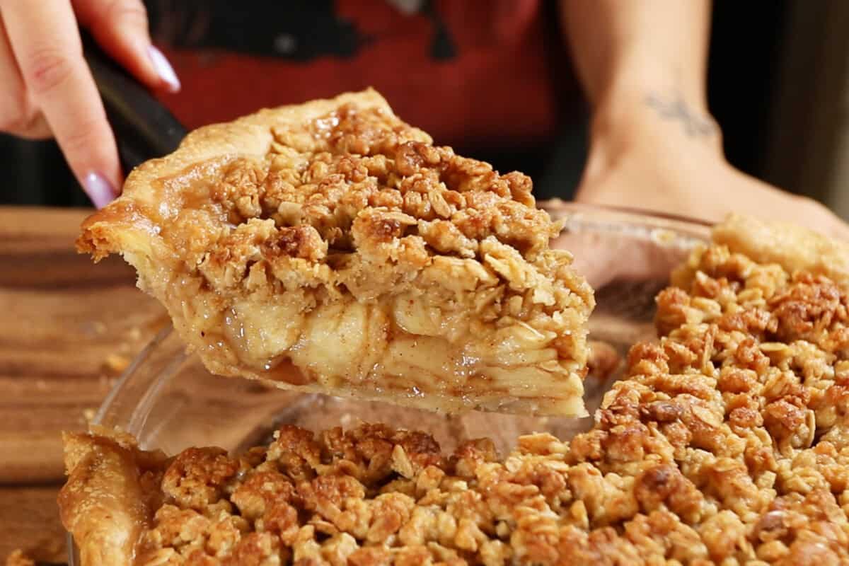lifting a slice of apple crumble pie