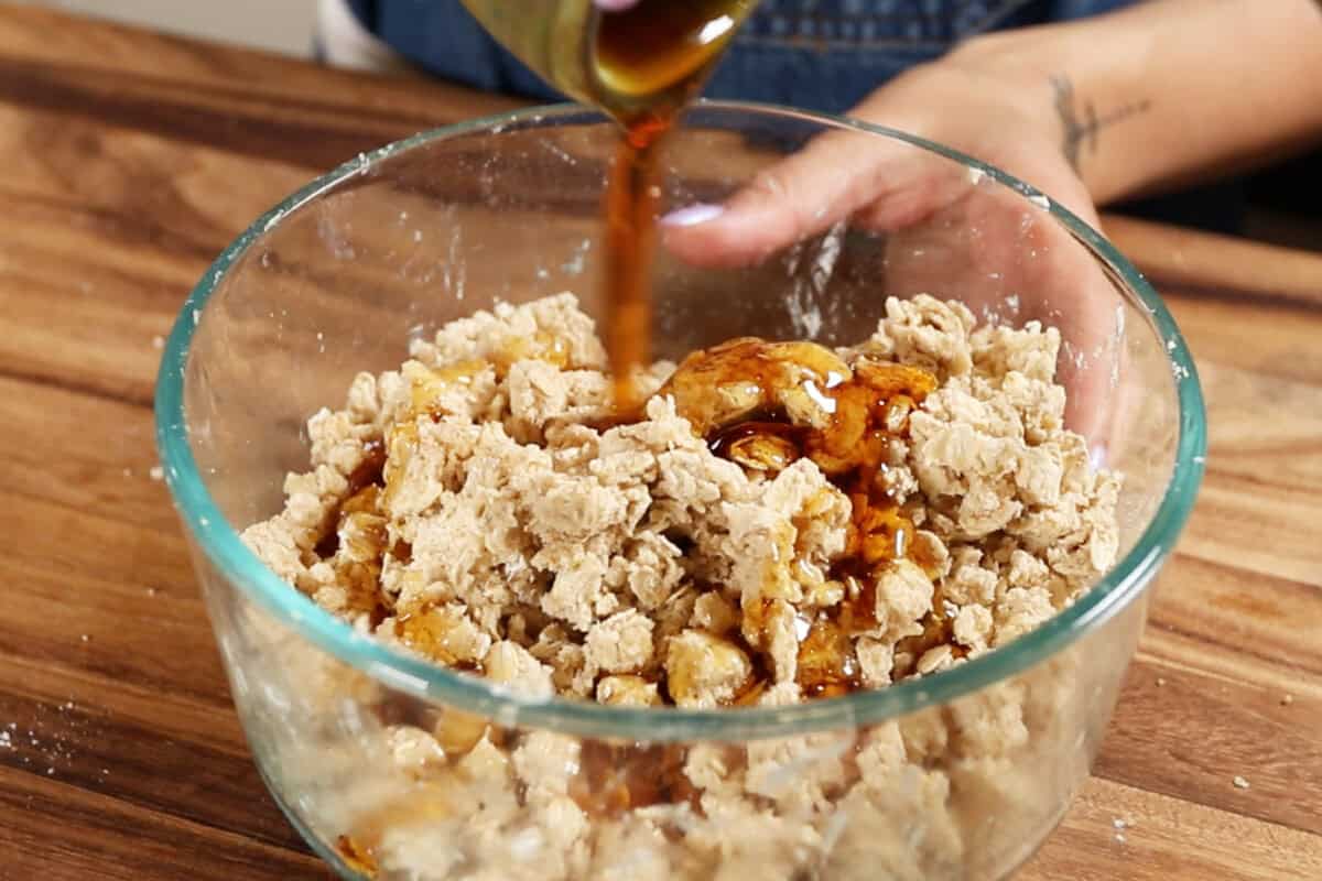 adding maple syrup in a bowl