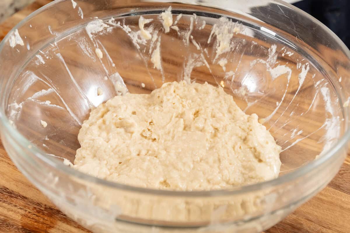 dough before rising in large glass bowl