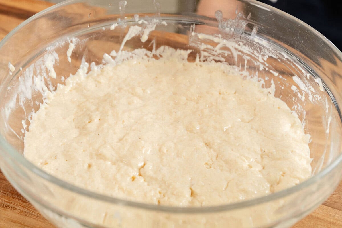 risen dough in large glass bowl
