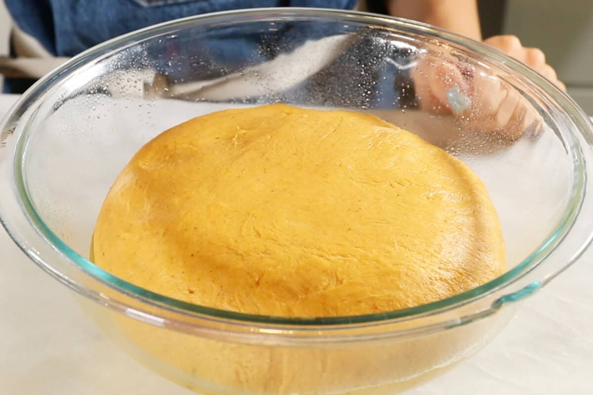 risen dough in a large glass bowl