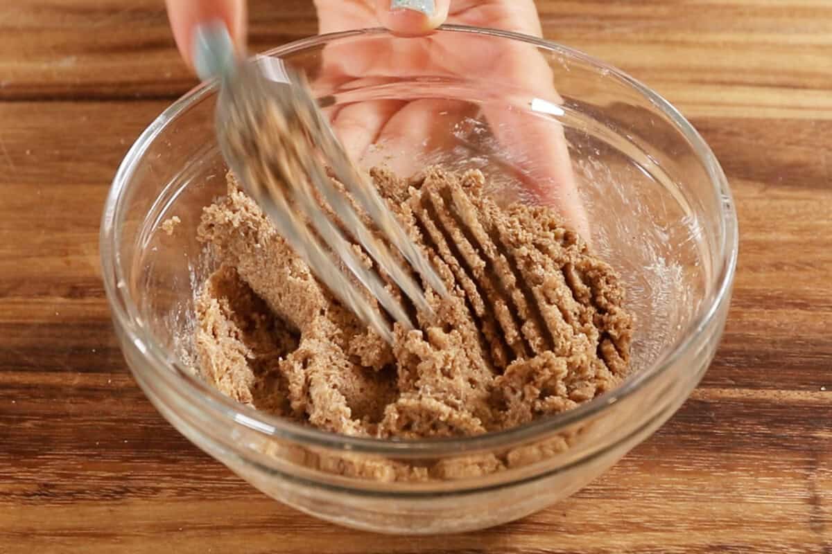 mixing cinnamon roll filling in small bowl