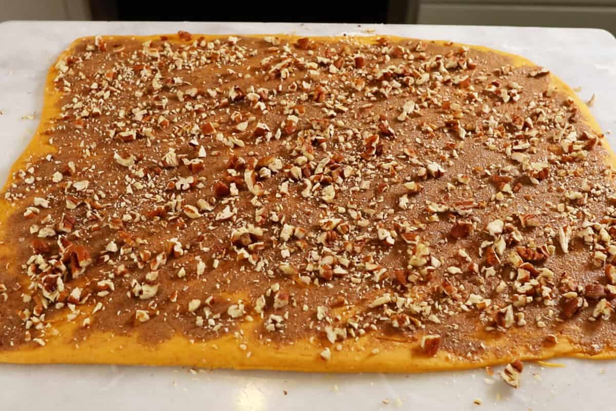 adding pecans to dough