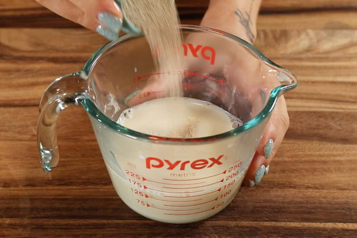 pouring active dry yeast into measuring cup