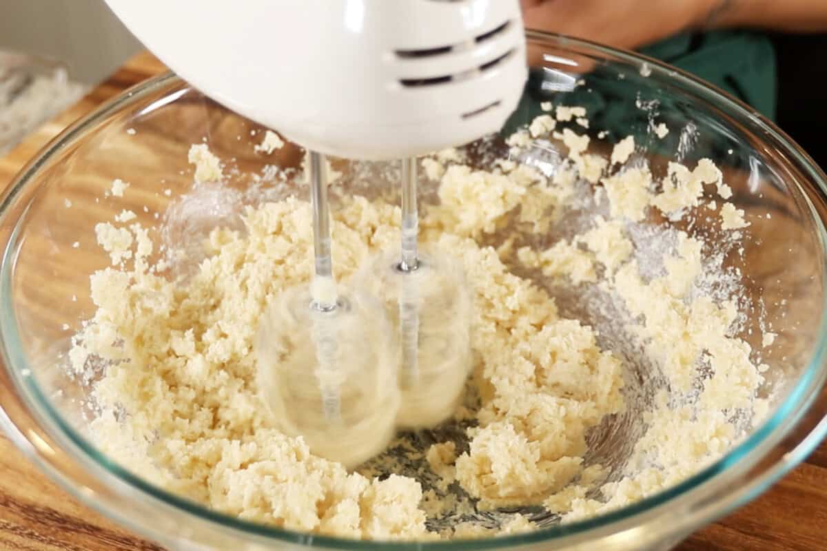 creaming butter and sugar in large glass bowl with hand mixer