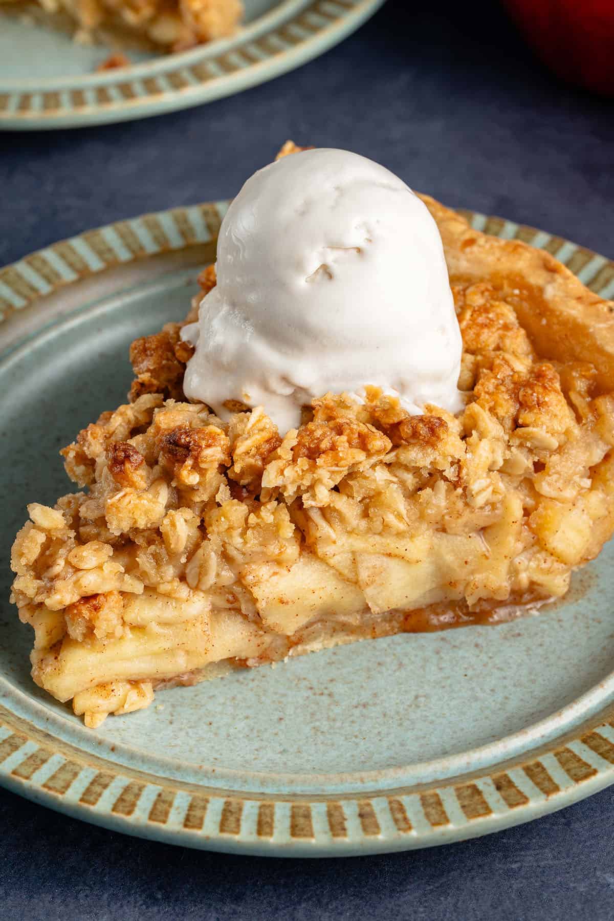 close up of apple crumble pie with ice cream on top