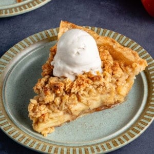 slice of apple crumble pie with a scoop of ice cream on top