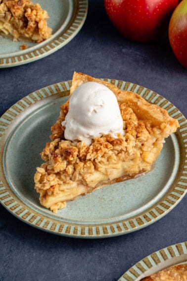 slice of apple crumble pie with a scoop of ice cream on top