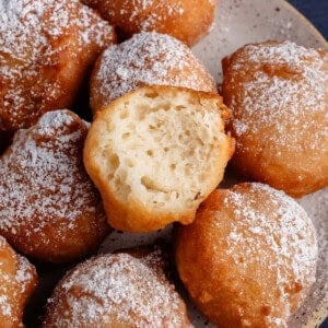 zeppole on plate with one bitten on top