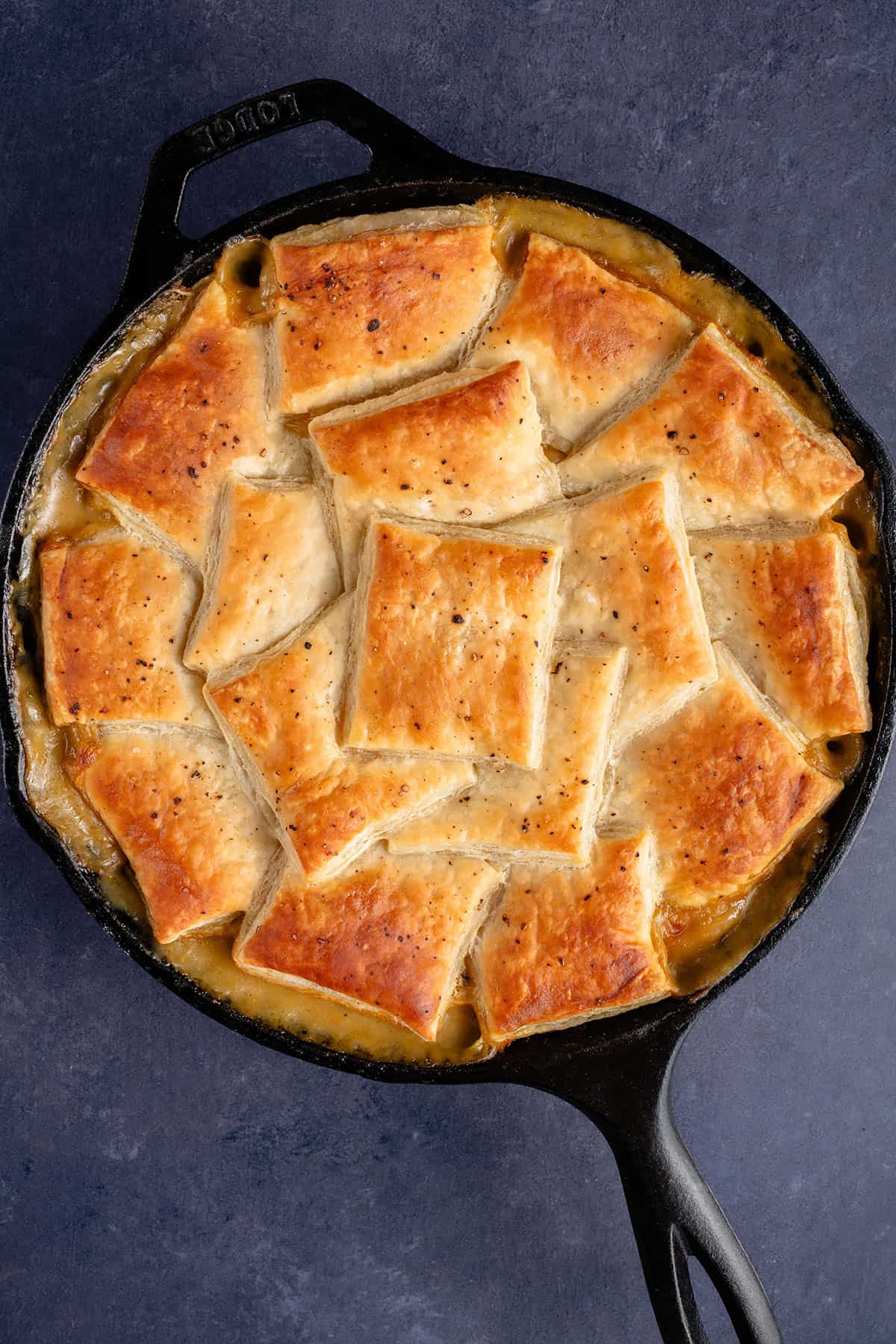 overhead photo of golden puff pastry squares with salt and pepper on top of a vegan mushroom pot pie
