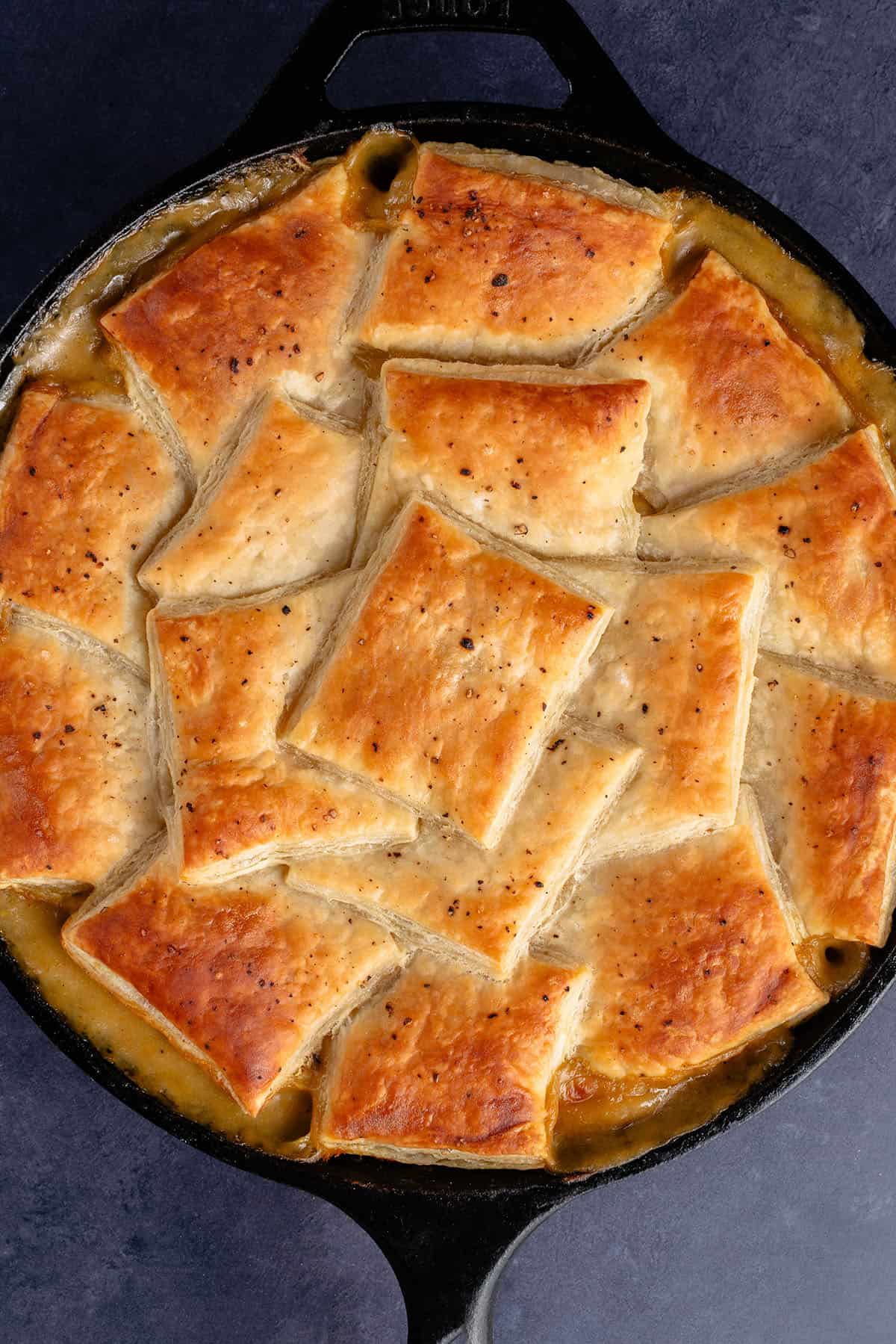 overhead photo of golden puff pastry squares with salt and pepper on top of a vegan mushroom pot pie