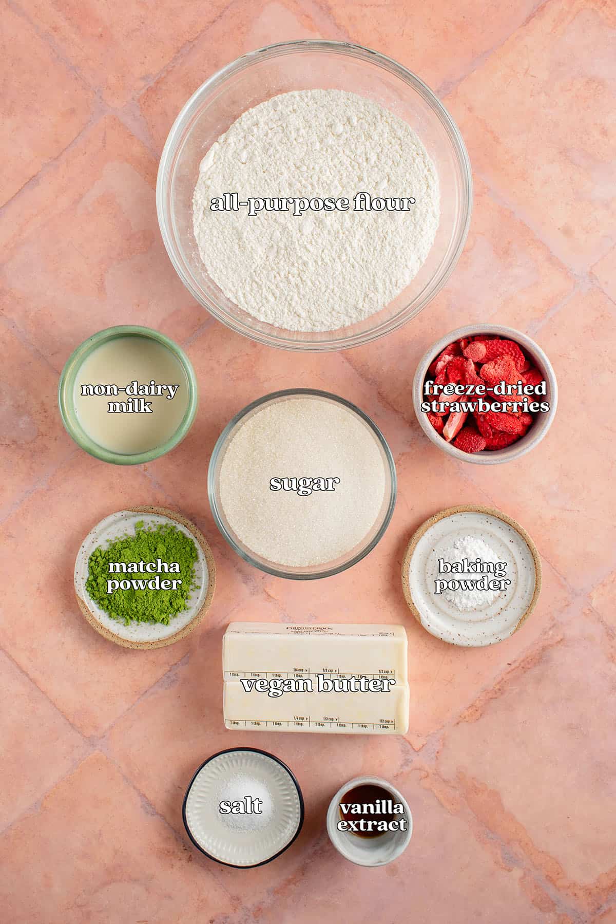 labeled ingredients for strawberry matcha cookies: all-purpose flour, non-dairy milk, sugar, freeze dried strawberries, matcha powder, baking powder, vegan butter, salt and vanilla extract.