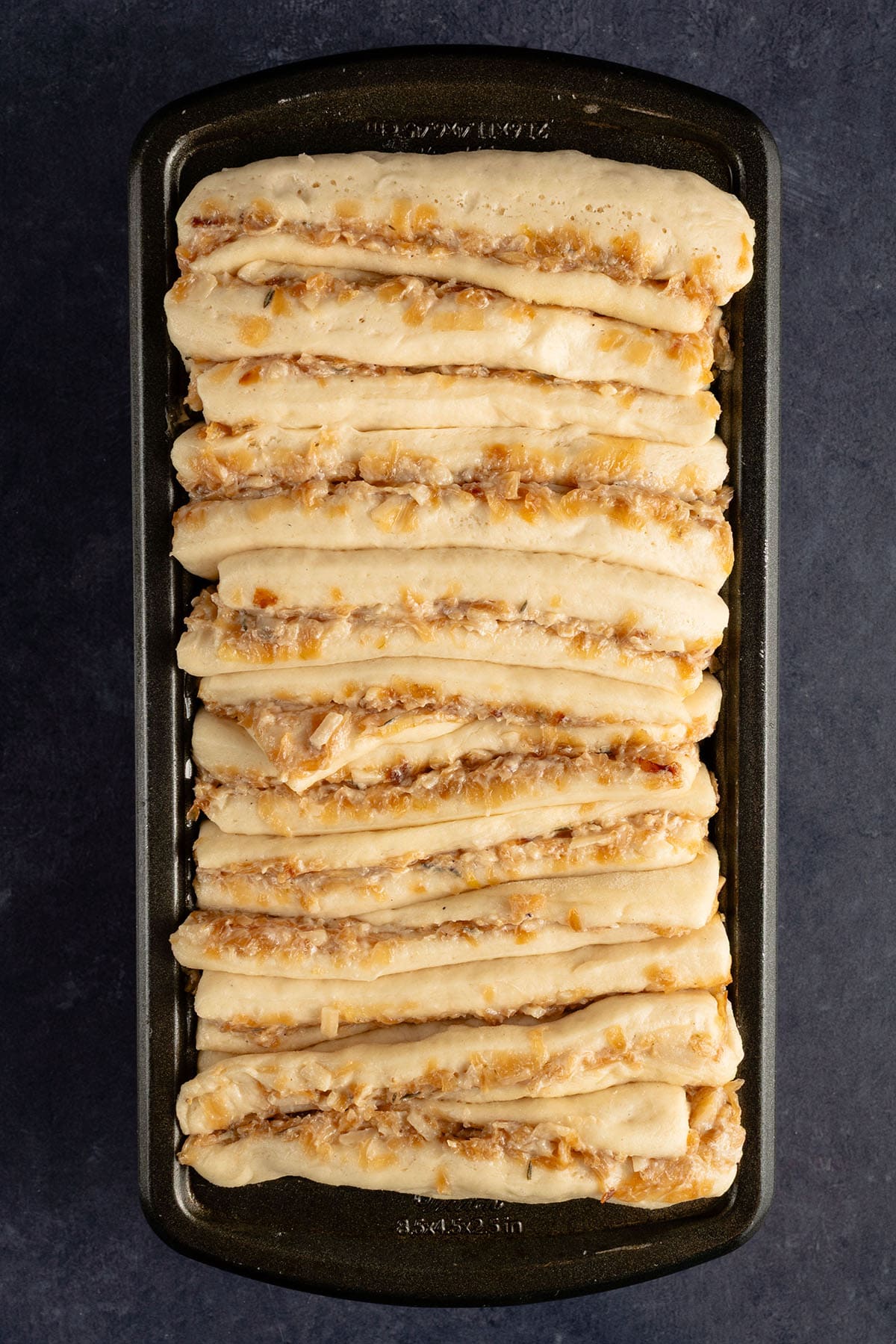 risen French Onion Pull Apart Bread in loaf pan before baking