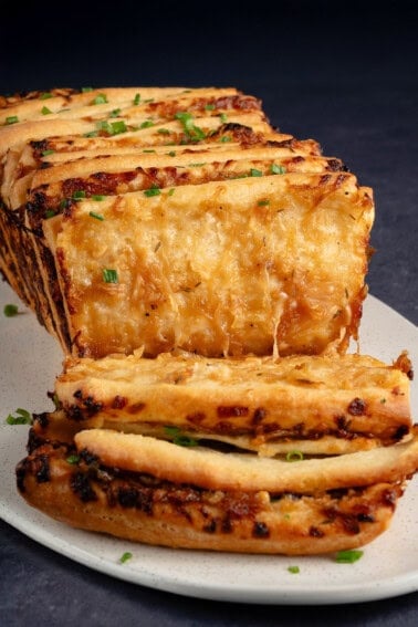 close up photo of vegan French Onion Pull Apart Bread serve on a white platter