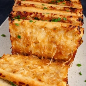 close up photo of vegan French Onion Pull Apart Bread serve on a white platter