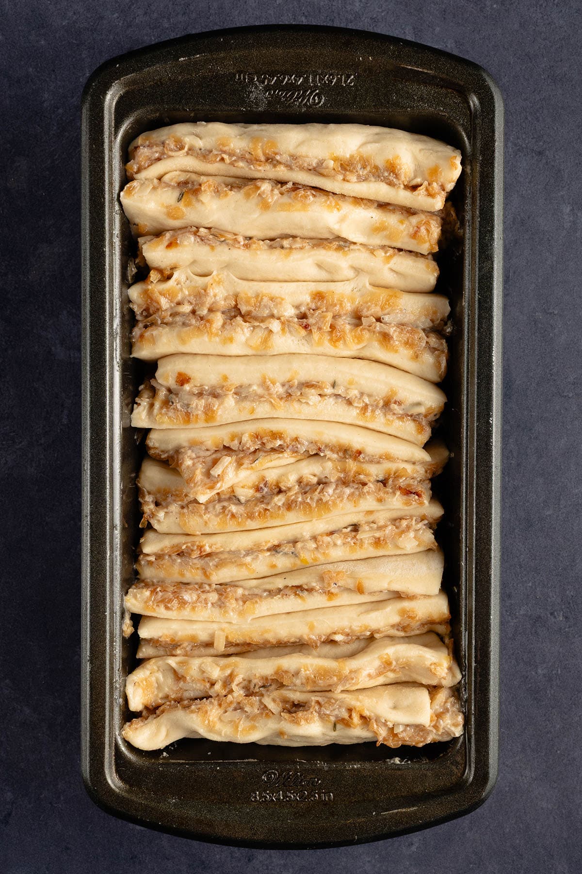 unbaked vegan French Onion Pull Apart Bread in loaf pan