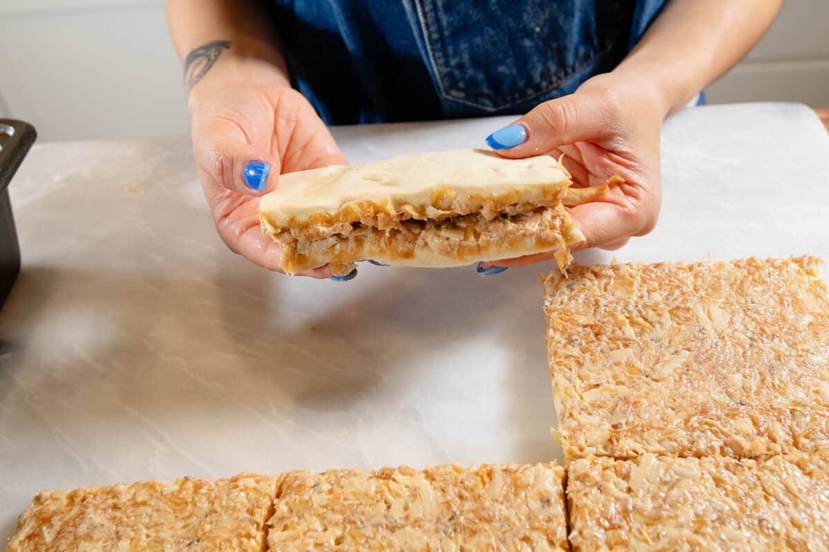 folding slices of dough for french onion pull-apart bread