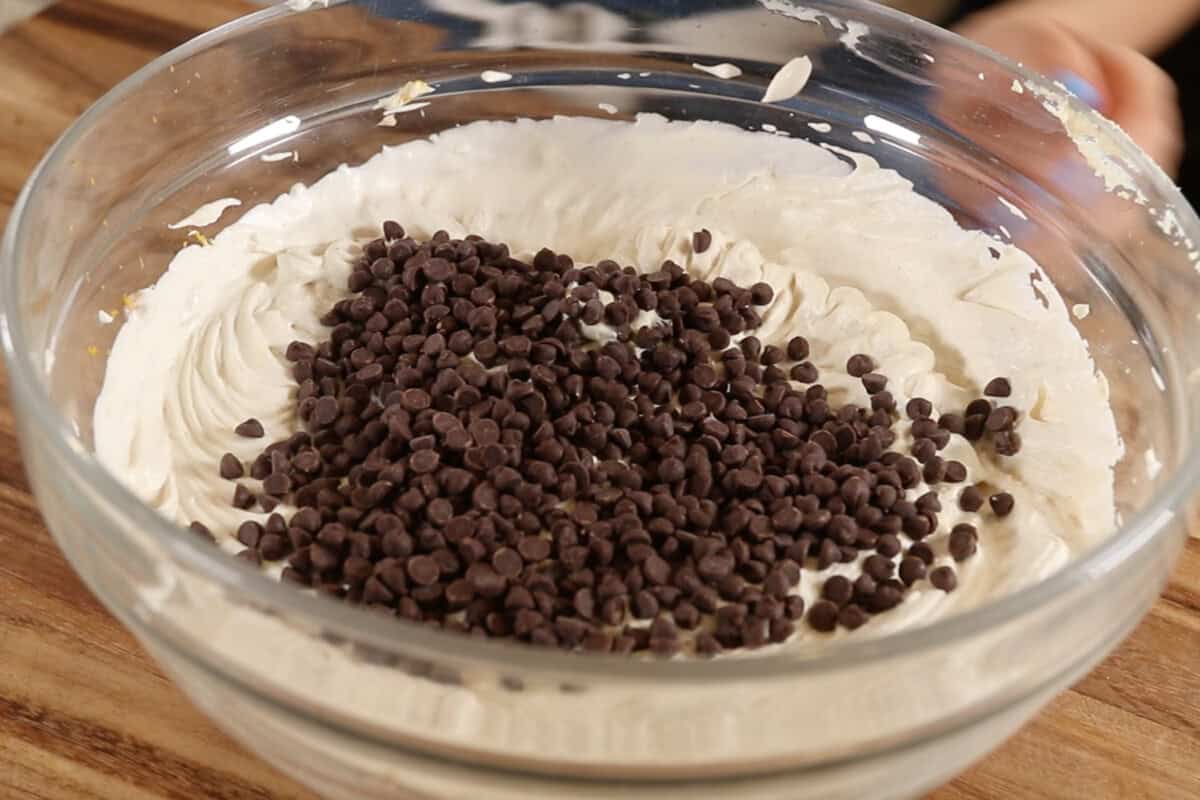 adding chocolate chips to cream