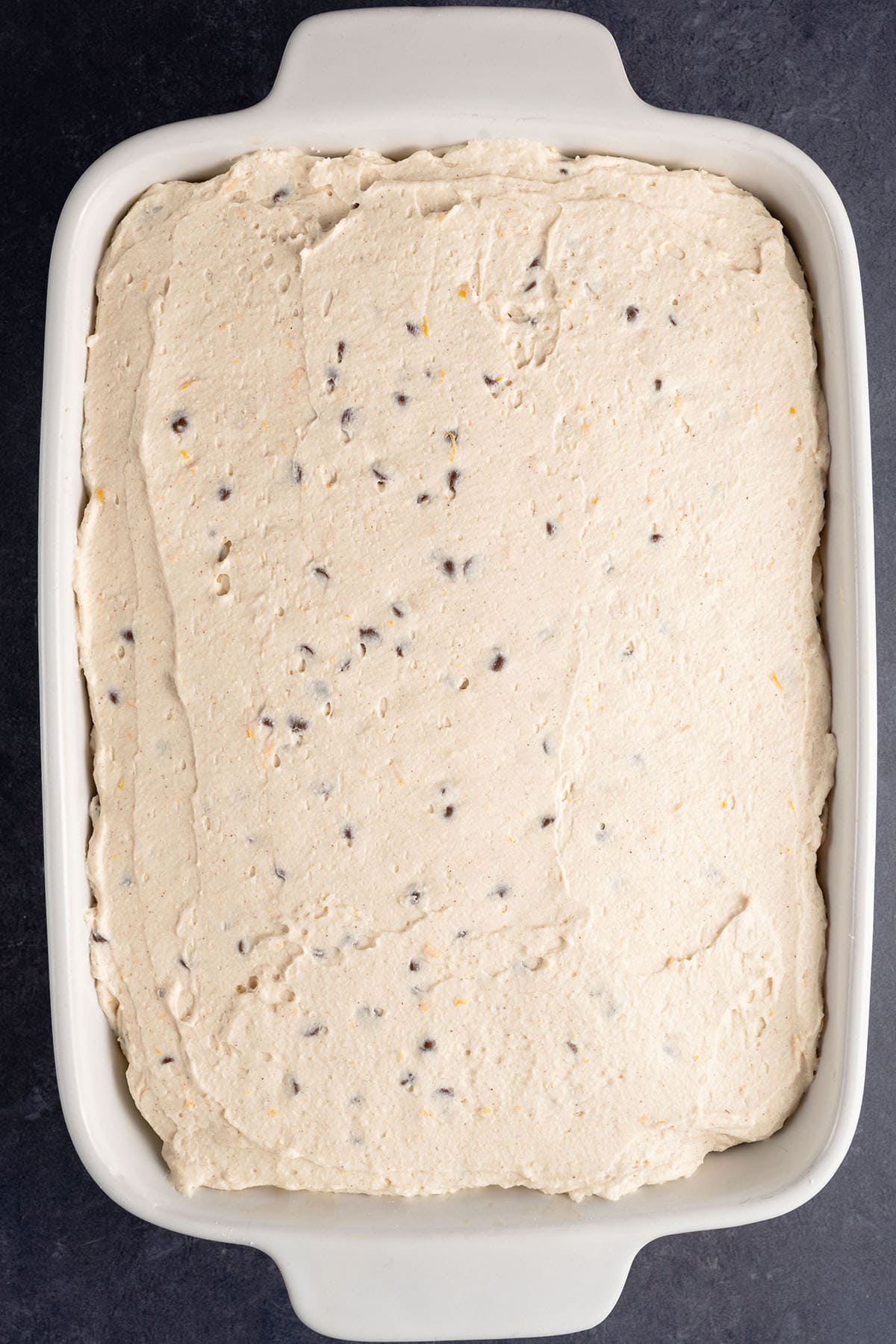 a tray of vegan cannoli tiramisu before being dusted