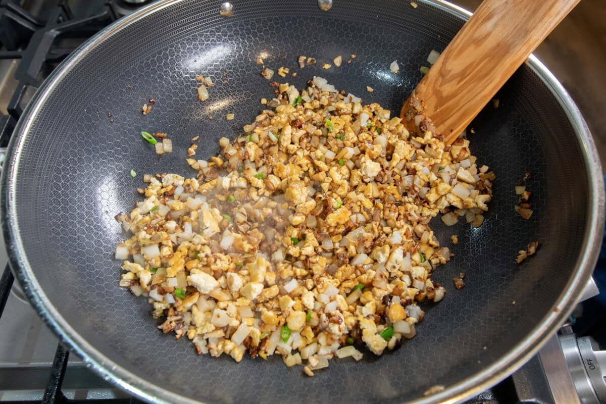 mixing the tofu filling in a large skillet