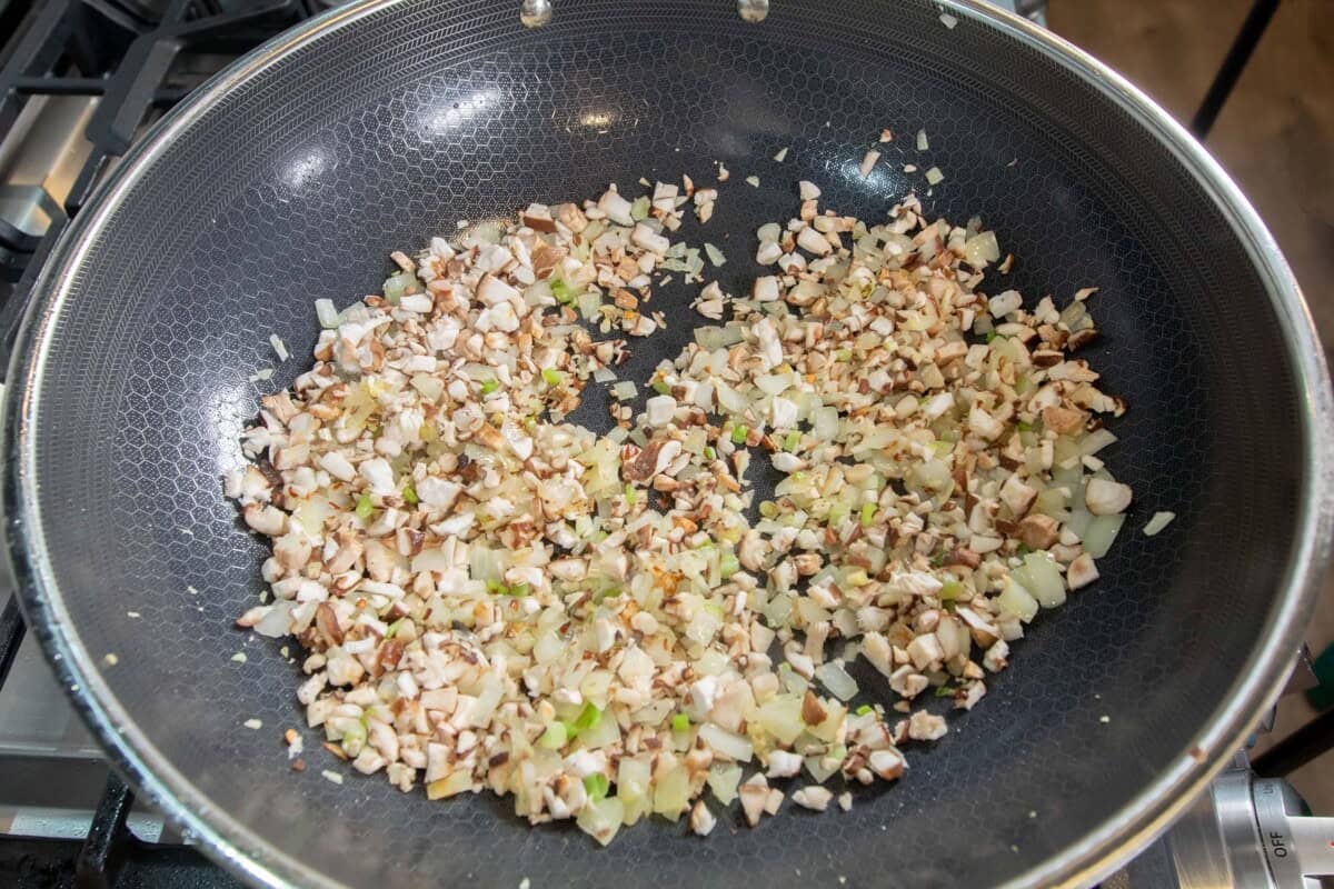 adding mushrooms to the skillet