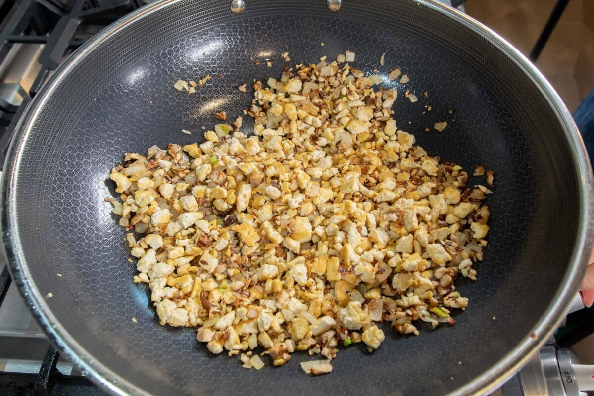 adding browned tofu into the skillet