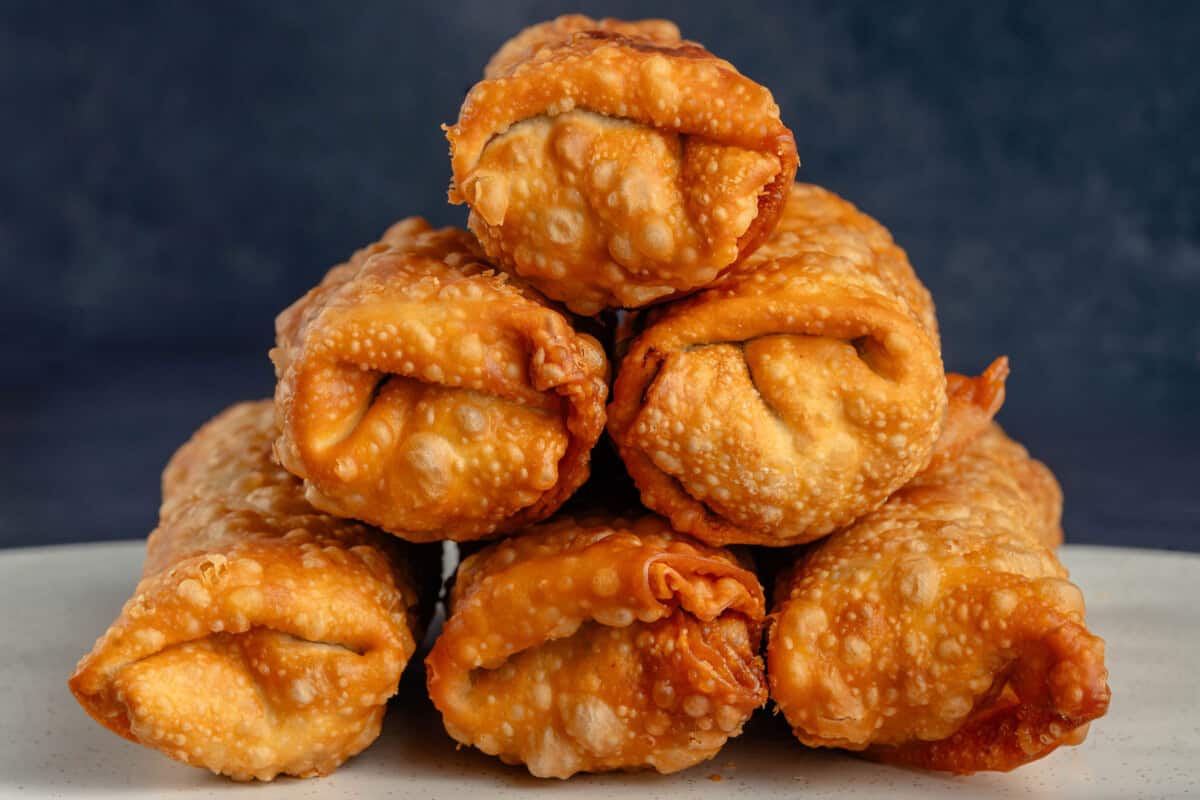 cheesesteak egg rolls stacked in a pyramid