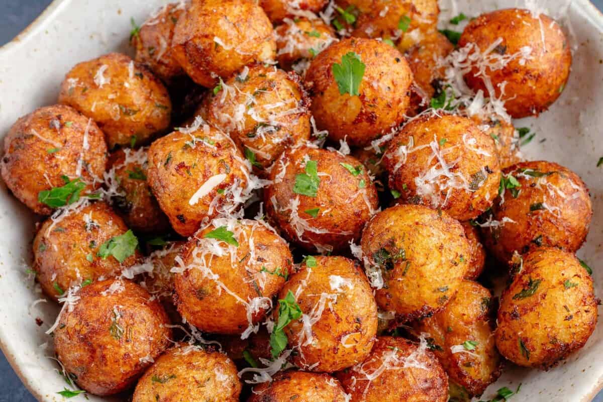 horizontal photo of vegan Crispy Potato Balls in white bowl