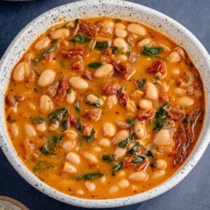 Bowl of Marry me Bean Soup with a side of parmesan