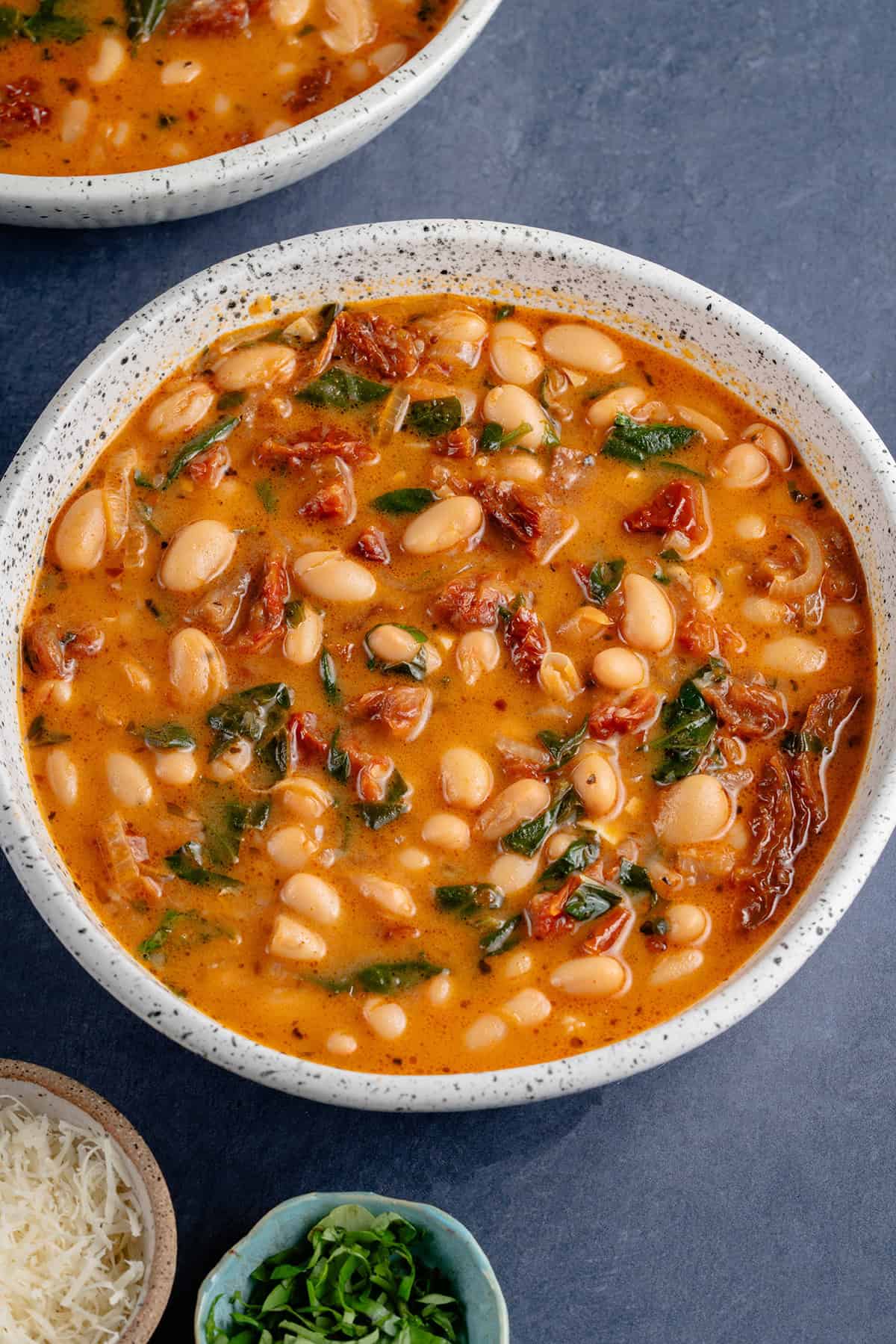Bowl of Marry me Bean Soup with a side of parmesan