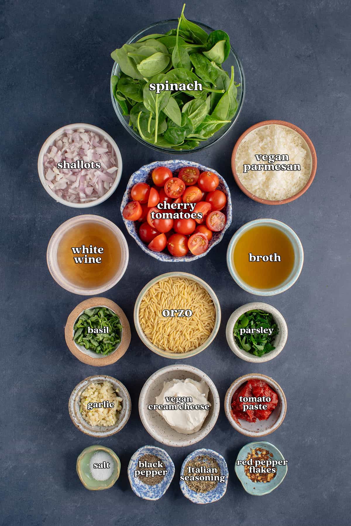 spinach, shallots, cherry tomatoes, vegan parmesan, white wine, broth, basil, orzo, parsley, garlic, vegan cream cheese, tomato paste, salt, black pepper, Italian seasoning, red pepper flakes