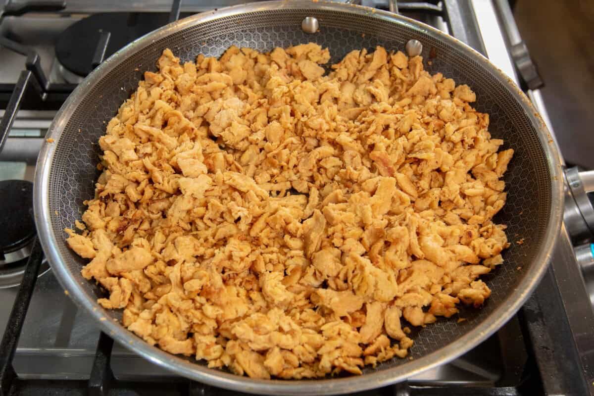soy curls being cooked in a skillet