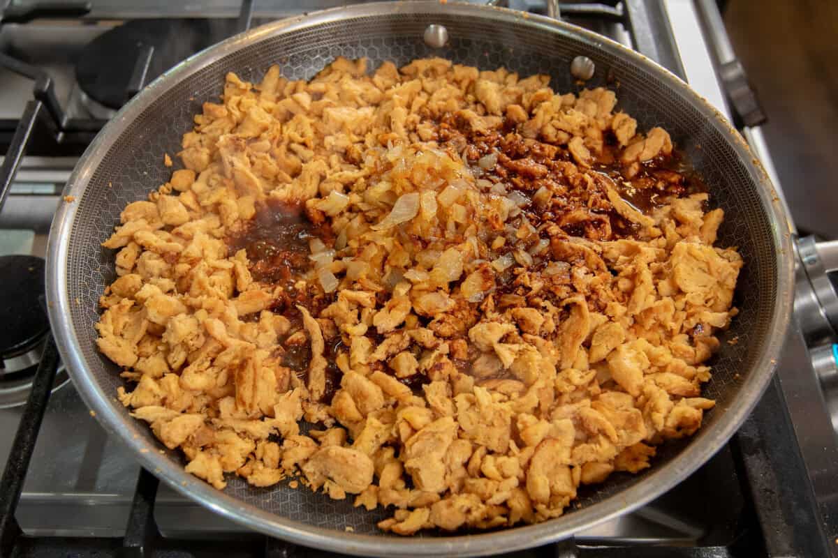 adding the marinade into the skillet with the soy curls