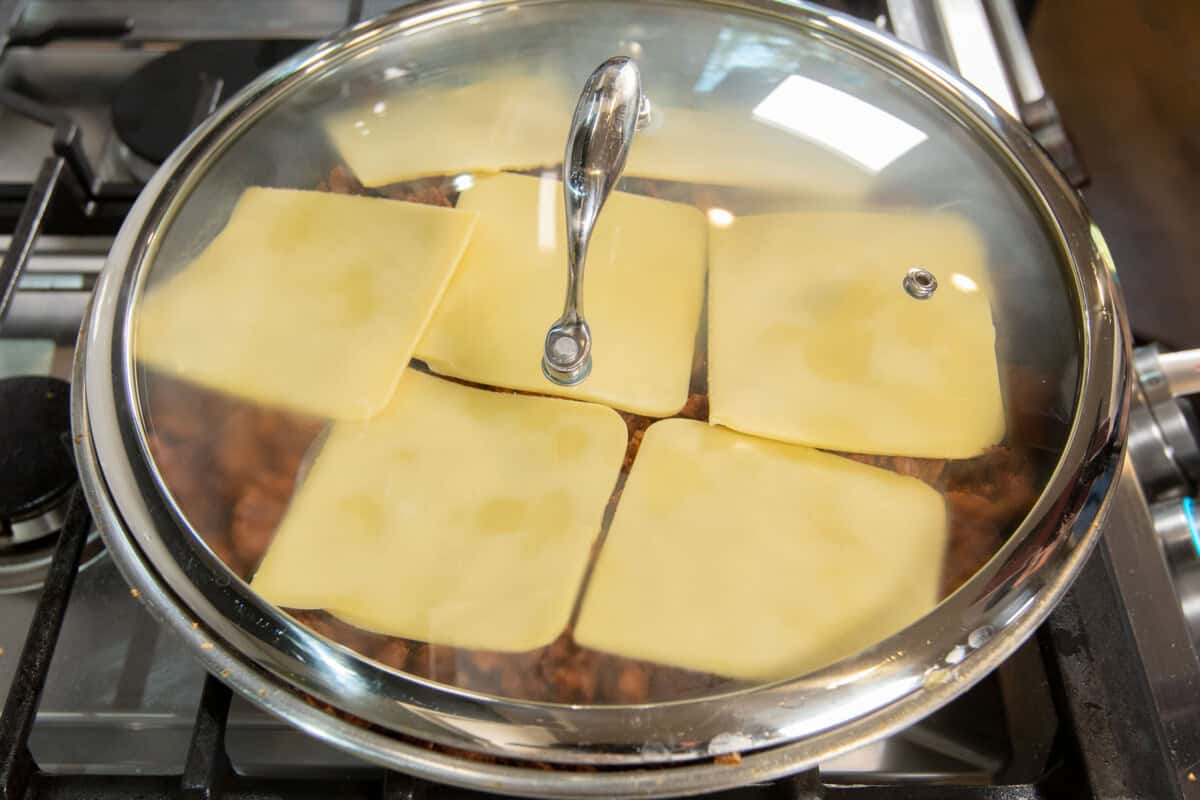 covering the skillet to melt the cheese