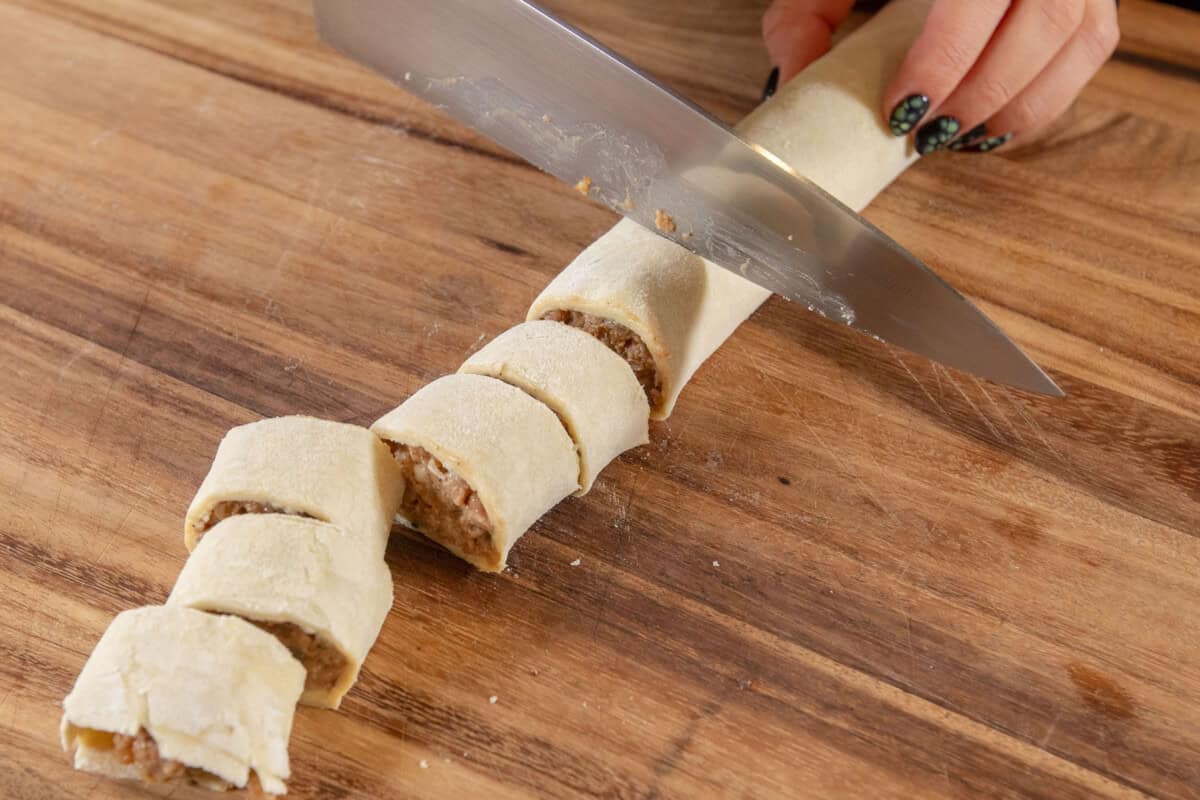 slicing sausage rolls