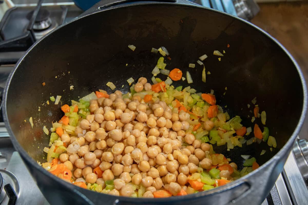 adding chickpeas to the pot