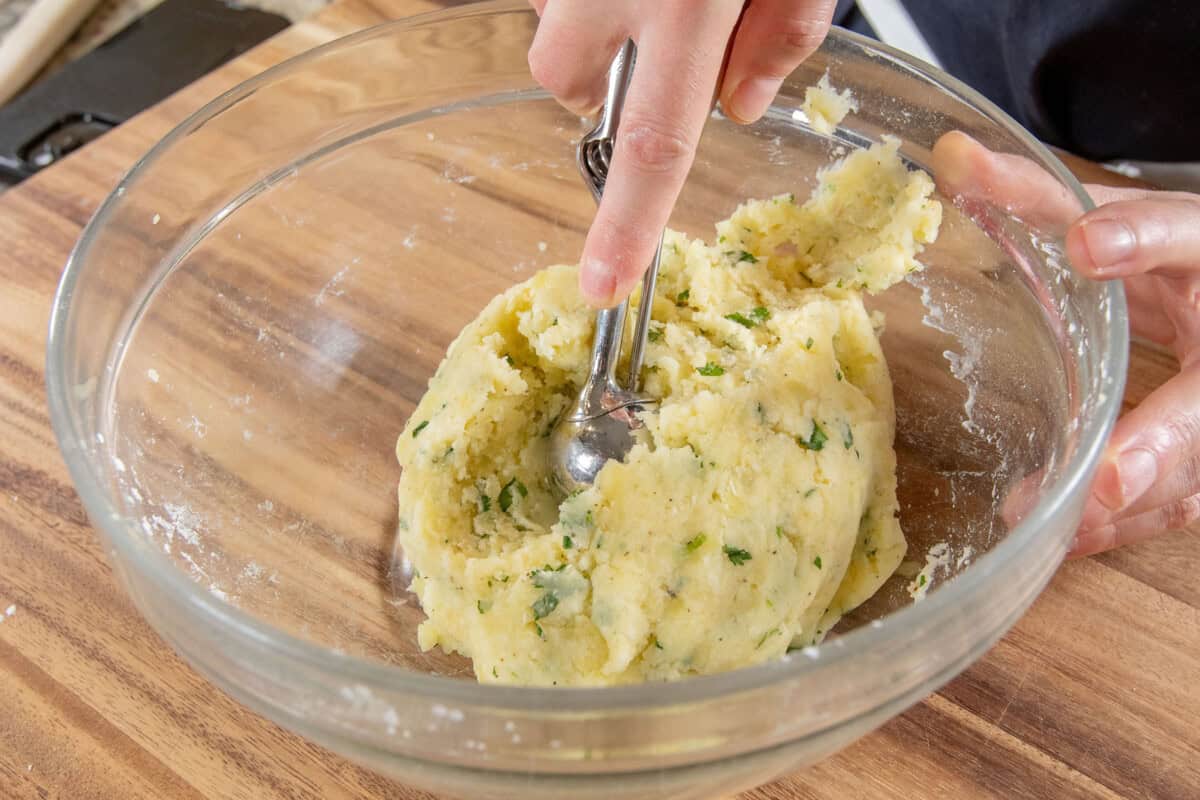 scooping mashed potato dough for crispy rice balls