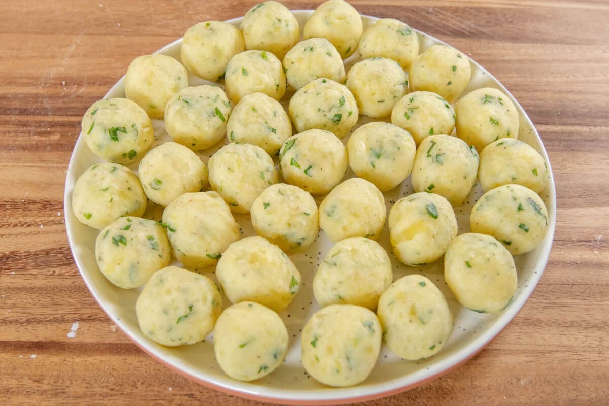 Crispy Potato Balls mixture on white plate before frying