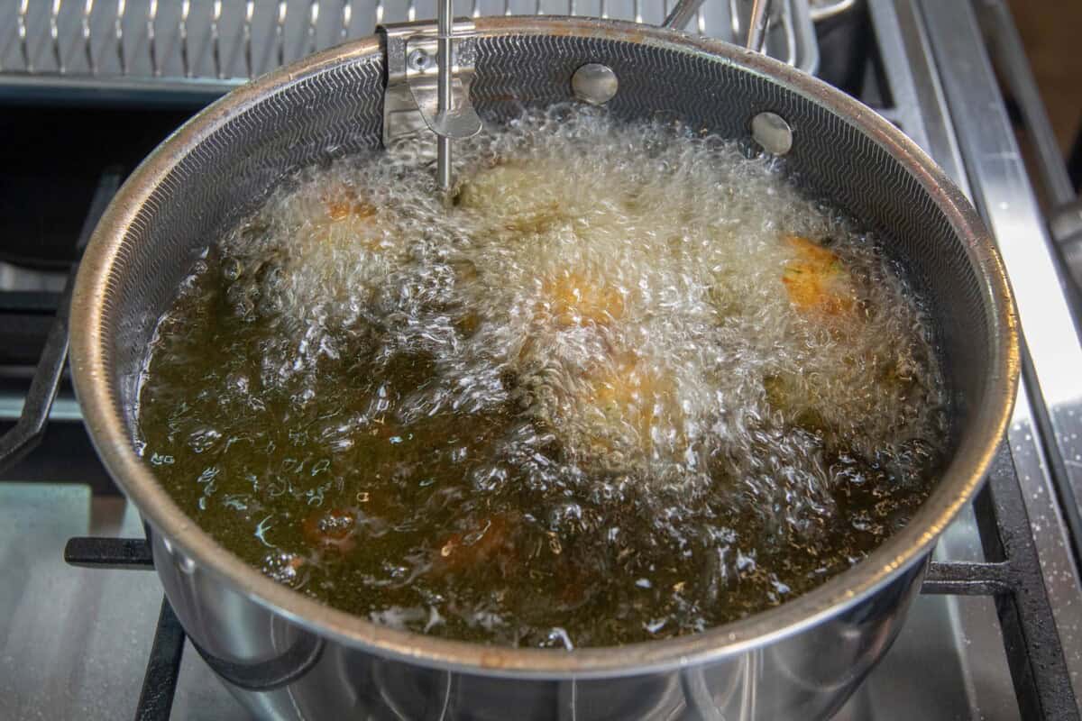frying Crispy Potato Balls in metal pot