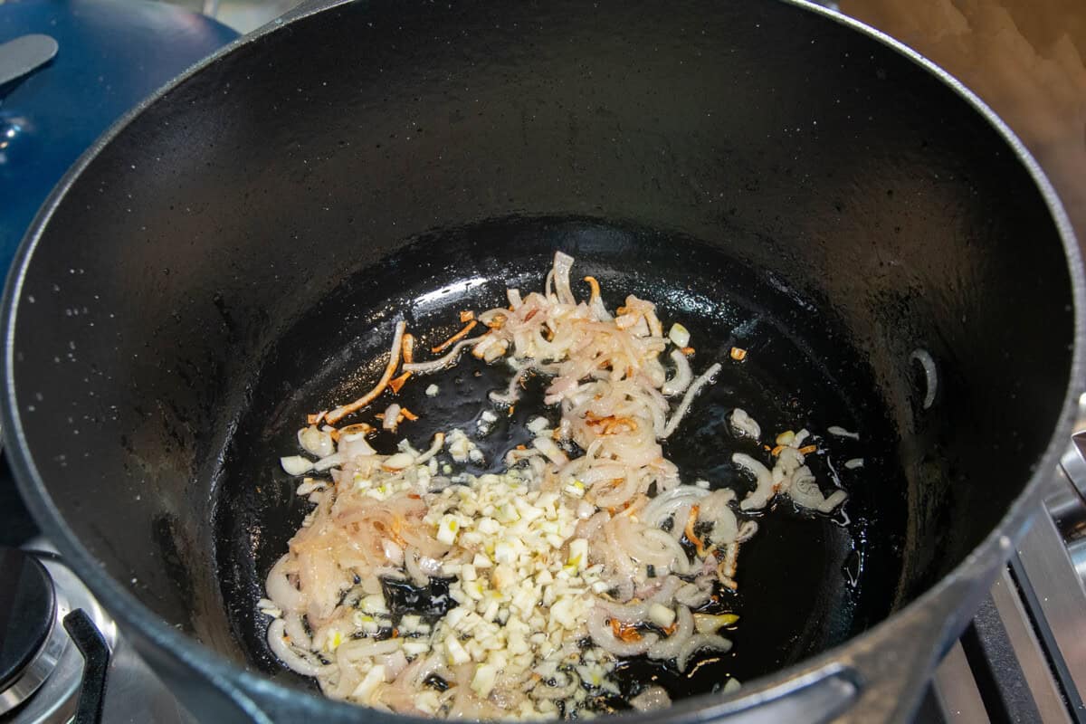 adding garlic to the pot