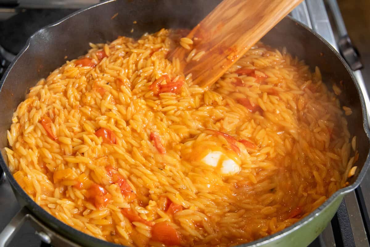 mixing in the vegan cream cheese to the pot