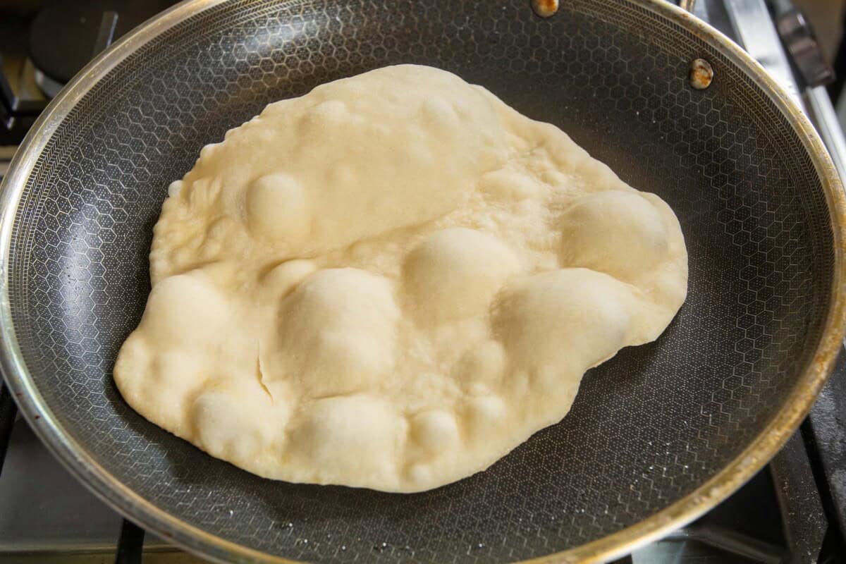 cooking flatbread in a large pan