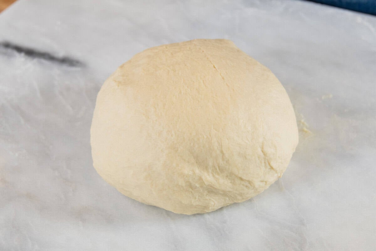Vegan dough ball ready for baking or cooking. Perfect for making bread, pizza, or pastries with plan.