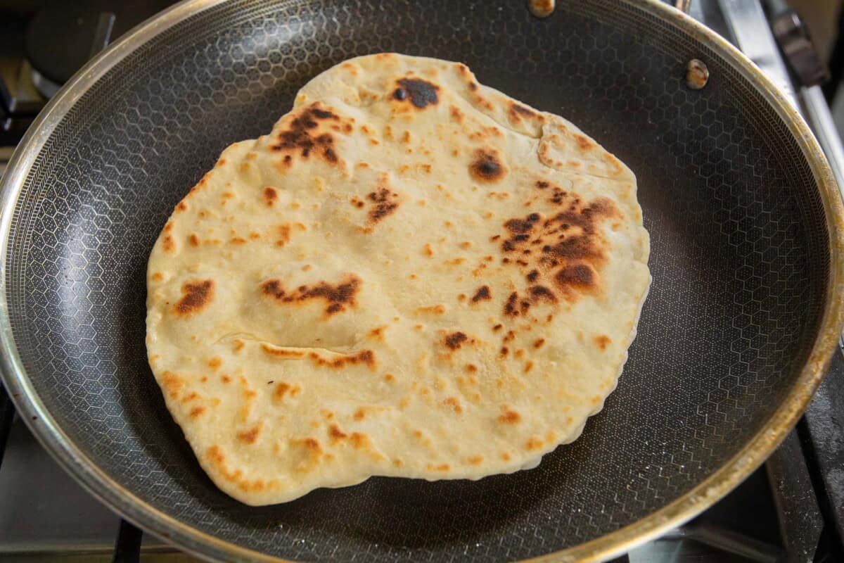 cooking flatbread in a large pan