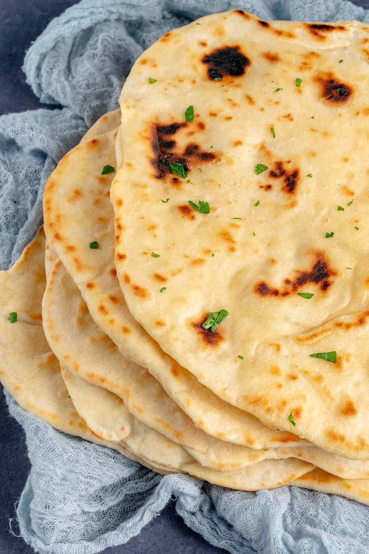 stack of tofu flatbreads on blue cloth