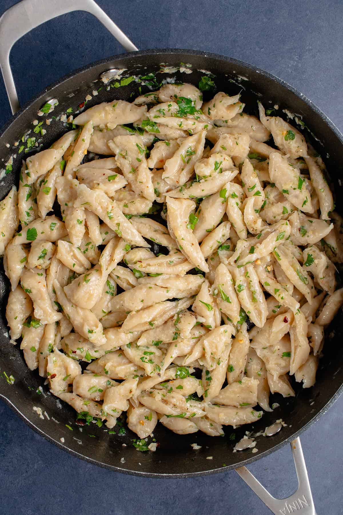 3-Ingredient Tofu Pasta in pan with garlic, olive, oil, and herbs