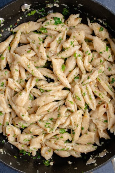 3-Ingredient Tofu Pasta in pan with garlic, olive, oil, and herbs